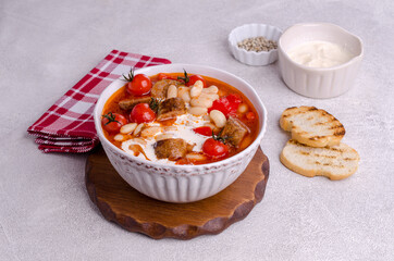 Beans soup with vegetables and sausages