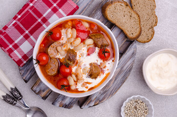 Beans soup with vegetables and sausages