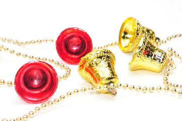 Christmas bells of red and gold color with a chain on a white background