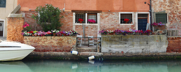 Flowers along the canal in Venice Italy.