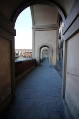 Fototapeta na wymiar Arches over sidewalk leading to the Ponte Vecchio bridge in Florence Italy.