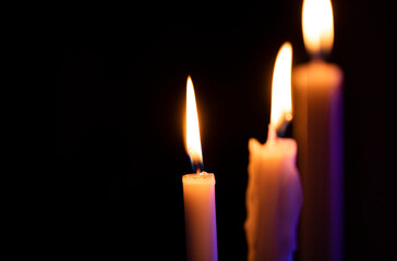 Dark background. Candle. Christmas light. 