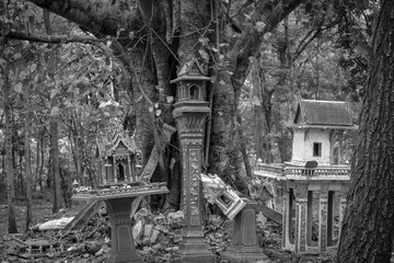 Black and white photo of old style thai house,Thai style spirit house old ruin was abandoned in the forest.