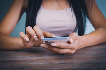 a young girl stands with a phone