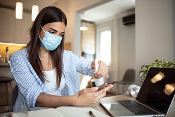 Young woman cleaning with antibacterial disposable wipes during COVID-19 pandemic at home