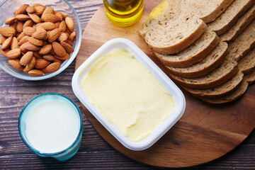 butter , milk, bread and almond nut on table 