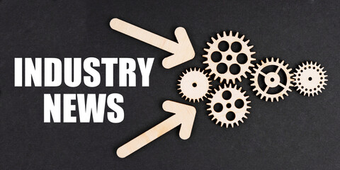 On the black surface, arrows, gears and an inscription - Industry News