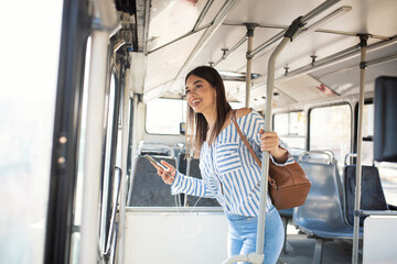 Woman Listening Music On Phone Riding In Bus