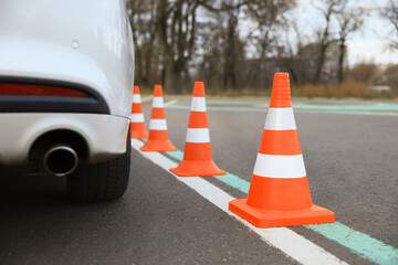 Modern car on test track with traffic cones, closeup. Driving school