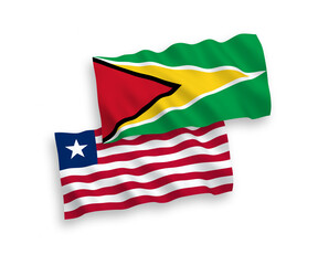 National vector fabric wave flags of Co-operative Republic of Guyana and Liberia isolated on white background. 1 to 2 proportion.