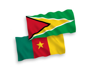 National vector fabric wave flags of Co-operative Republic of Guyana and Cameroon isolated on white background. 1 to 2 proportion.