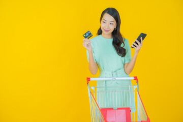 Portrait beautiful young asian woman smile with grocery basket