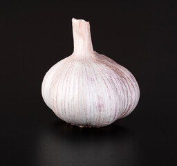 Garlic in pink husk, isolated on a black background