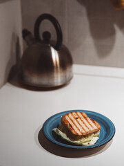 Sandwich with kettle on a kitchen counter