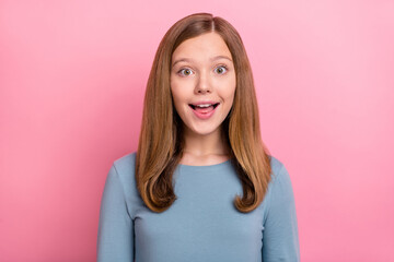 Portrait of attractive amazed cheerful brown-haired girl good news reaction isolated over pink pastel color background