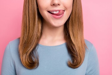 Cropped view portrait of attractive cheerful hungry funny girl licking lip isolated over pink...