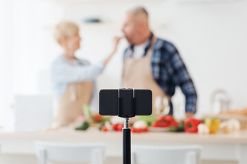 Blogger tasting food, family teaching people to cook healthy eat and shoot video on smartphone webcam