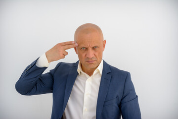 A brutal, bald man shows a shot to the head with a hand gesture. An elegant man with his hands shows a gesture, think with your head. A confident man in a business suit is gesturing.