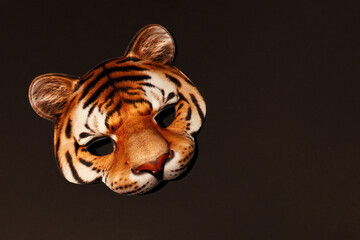 Orange Tiger striped masquerade face mask with realistic print of wildcat muzzle. Tiger is Symbol...