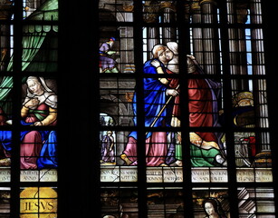 Fototapeta na wymiar Stained Glass Window Detail Depicting Two Embracing Women at the Oude Kerk Church in Amsterdam, Netherlands