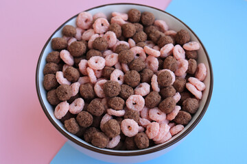 corn flakes different shapes chocolate and strawberry on the pink-blue background