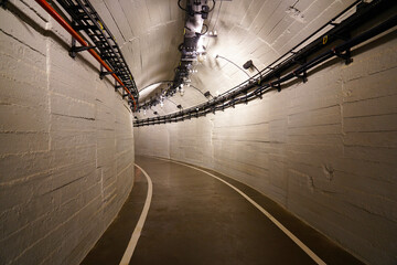 A long corridor in a factory along which trays with wires are laid, a military facility, an...