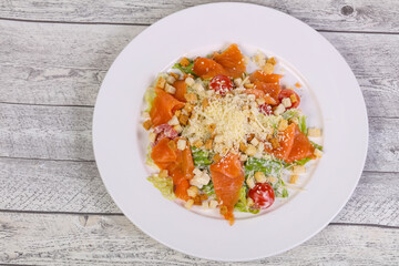 Caesar salad with salmon and parmesan