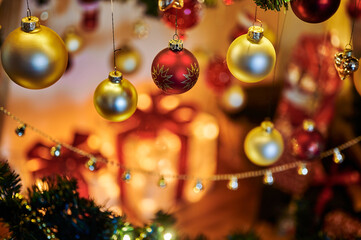 Christmas decoration with red and gold baubles and an unfocussed background.