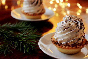 Tasty tartlets with whipped cream on a plate