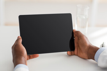 Technology for treat. Unrecognizable african american doctor using digital tablet with blank screen, empty space