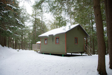 Old log cabin in the Canadian forest in winter in the province of Quebec