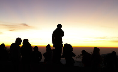 Fototapeta na wymiar Silhouette scenery of group of a man with dawn background. 