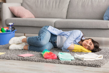 Tired woman lying on floor carpet and sleeping