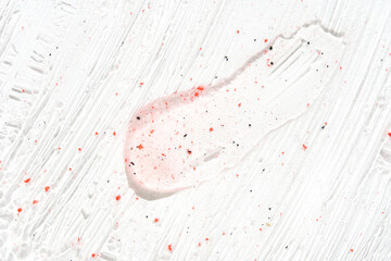 Face scrub texture. Cream skincare cosmetic. Organic stroke. Feet oily cleanser smudge. Particles in gel. White background. Top view. Fluid treatment