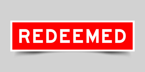 Square label banner with word redeemed in red color on gray background