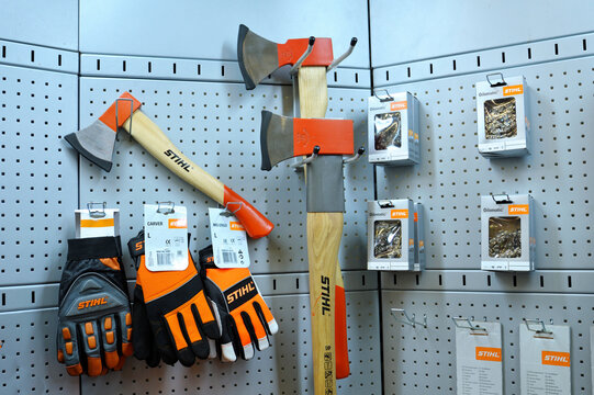 Stand with a part of fire-fighting equipment: fire axes, gloves and chains for chain saws in packages, Stihl