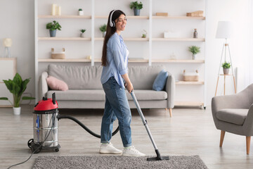 Woman cleaning house, singing and using hoover