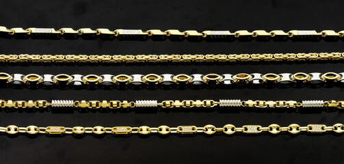 Gold jewellery. Gold chains on black background