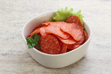 Sliced pepperoni sausage in the bowl