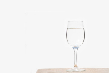 water in a glass on a wooden bar White background. voshka in a glass