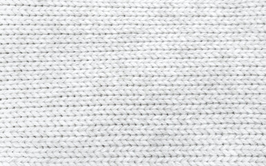 Soft knitted sweater texture closeup. Light abstract background. The trendy white backdrop for web design. Luxury fabric backplate pattern