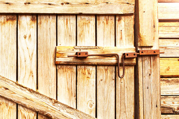 Wooden door to the barn or horse stall, lock on the door. 