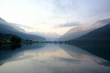 Amazing view of a calm mountain lake in the morning light. It is Oppstrynsvatn  lake in the municipality of Stryn in the county of Sogn og Fjord