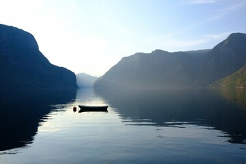 Amazing scenery of boat standing on calm water of Aurlandsfjord in Norway in evening light. Aurlandsfjord is one of most beautiful fjords in Norway