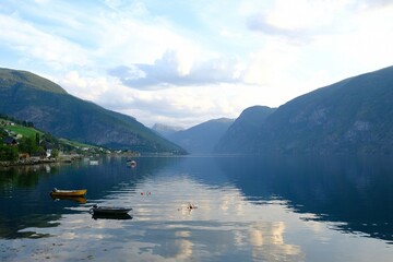 Amazing scenery of boats sanding on calm water of Aurlandsfjord in Norway in evening light. Aurlandsfjord is one of most beautiful fjords in Norway