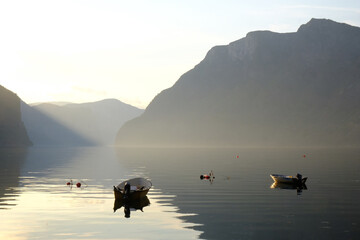 Amazing scenery of boats sanding on calm water of Aurlandsfjord in Norway in evening light. Aurlandsfjord is one of most beautiful fjords in Norway
