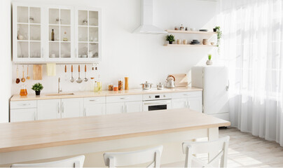 Light kitchen design with white wooden furniture and island, utensils and kitchenware on shelves, range hood
