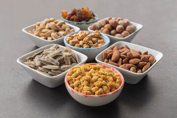 Dried mulberry in selective focus. Sunflower , hazelnuts, pistachios, grapes, almonds, yellow chickpeas and peanuts in shell .