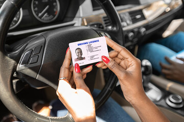 Closeup of driving license in black lady hands