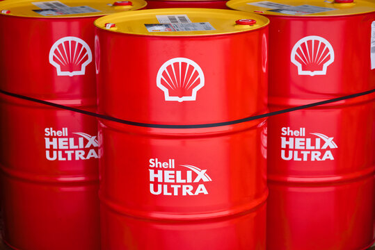 Minsk, Belarus. Dec 2021. Shell Helix Ultra steel drums with motor oil ready for transportation on wooden pallet. Royal Dutch Shell premium lubricant products. Oil barrels stacked at warehouse.